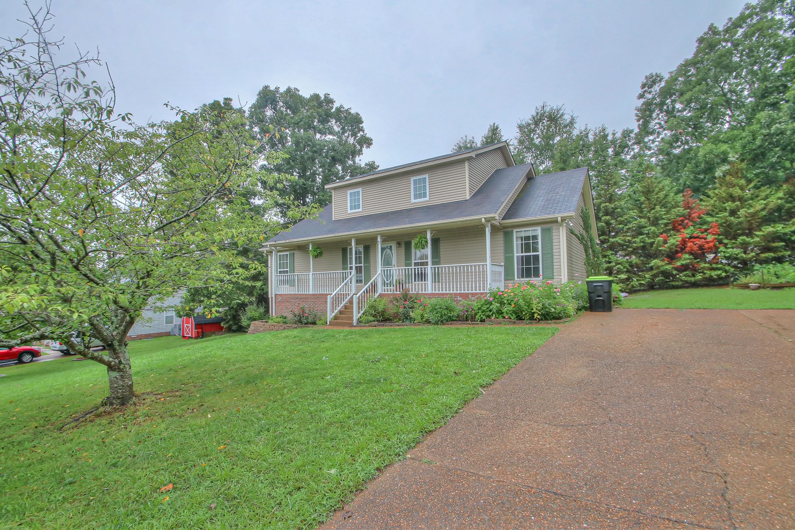 7481 Christopher Street Fairview, TN 37062 - Photo 3 of 42 a front view of a house with a yard and garage