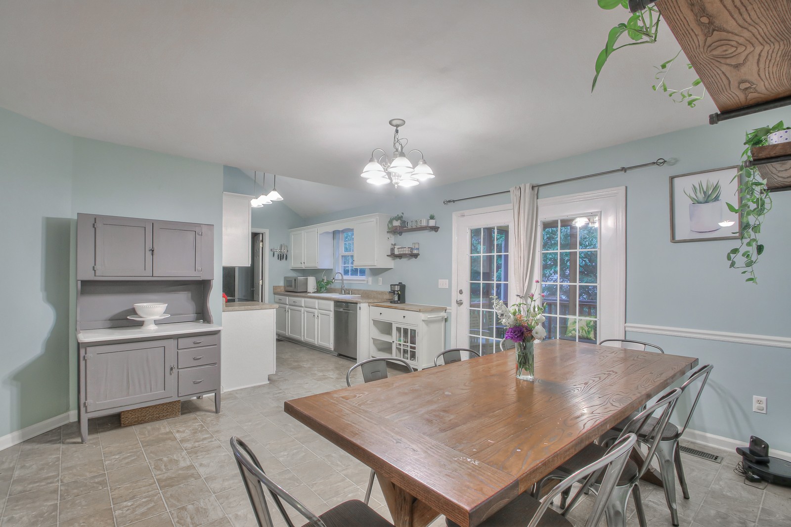 7481 Christopher Street Fairview, TN 37062 - Photo 34 of 42 a open kitchen with kitchen island a stove a table and chairs in it