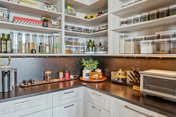 a kitchen with lots of clutter and cabinets