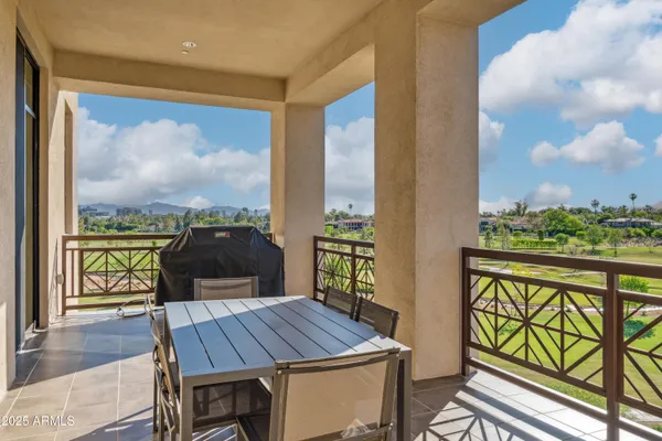 a view of a city from a balcony with furniture