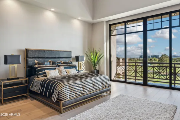 a bedroom with a large bed and a balcony view