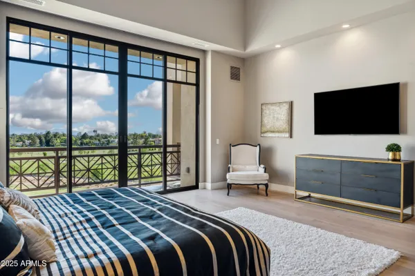 a bedroom with a bed and large window