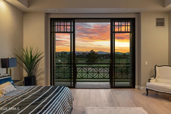 a bedroom with a large bed and a large window