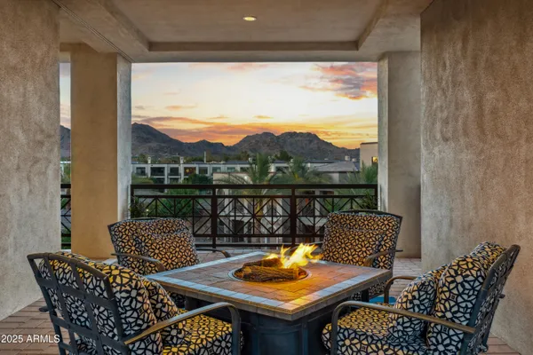 a view of a balcony with two chairs and a table