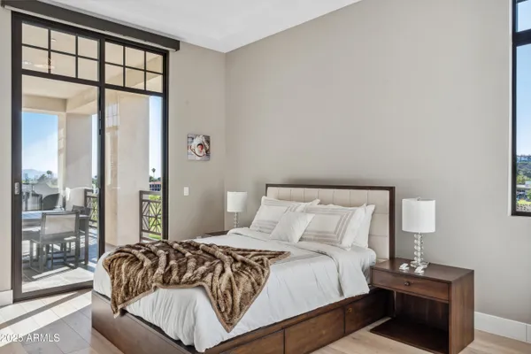 a bedroom with a bed and a large window