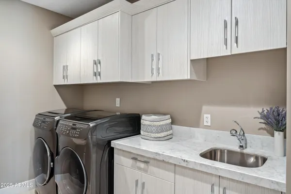 a kitchen with granite countertop a sink a stove and cabinets