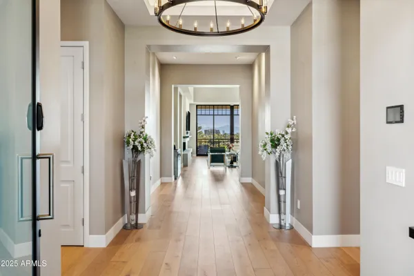 a view of a hallway with wooden floor and a livingroom