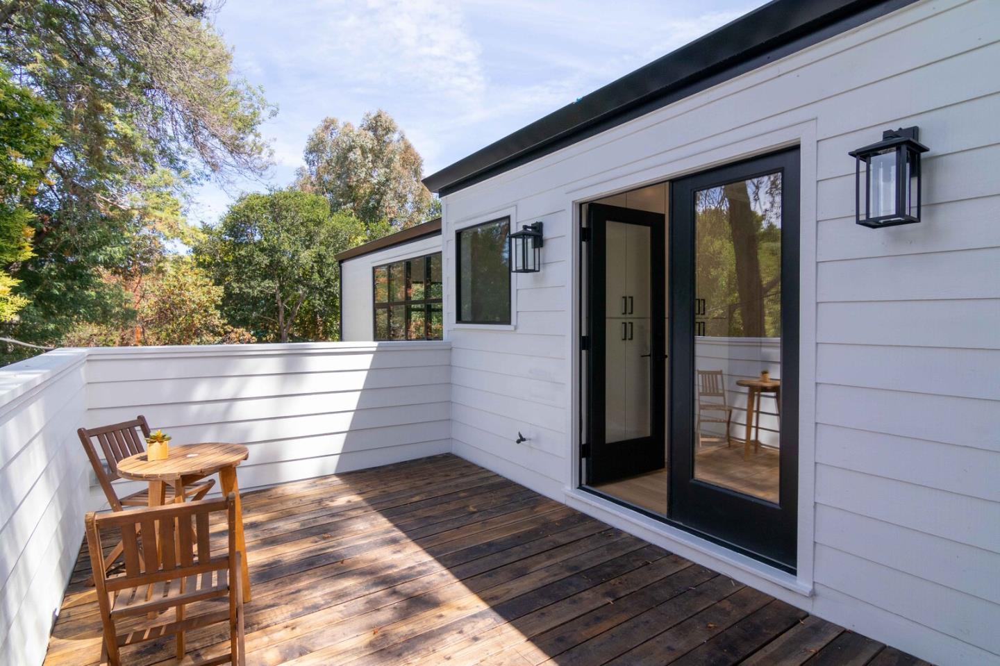 2465 Alpine Road Menlo Park, CA 94025 - Photo 19 of 28 a view of a patio with table and chairs with wooden floor and fence