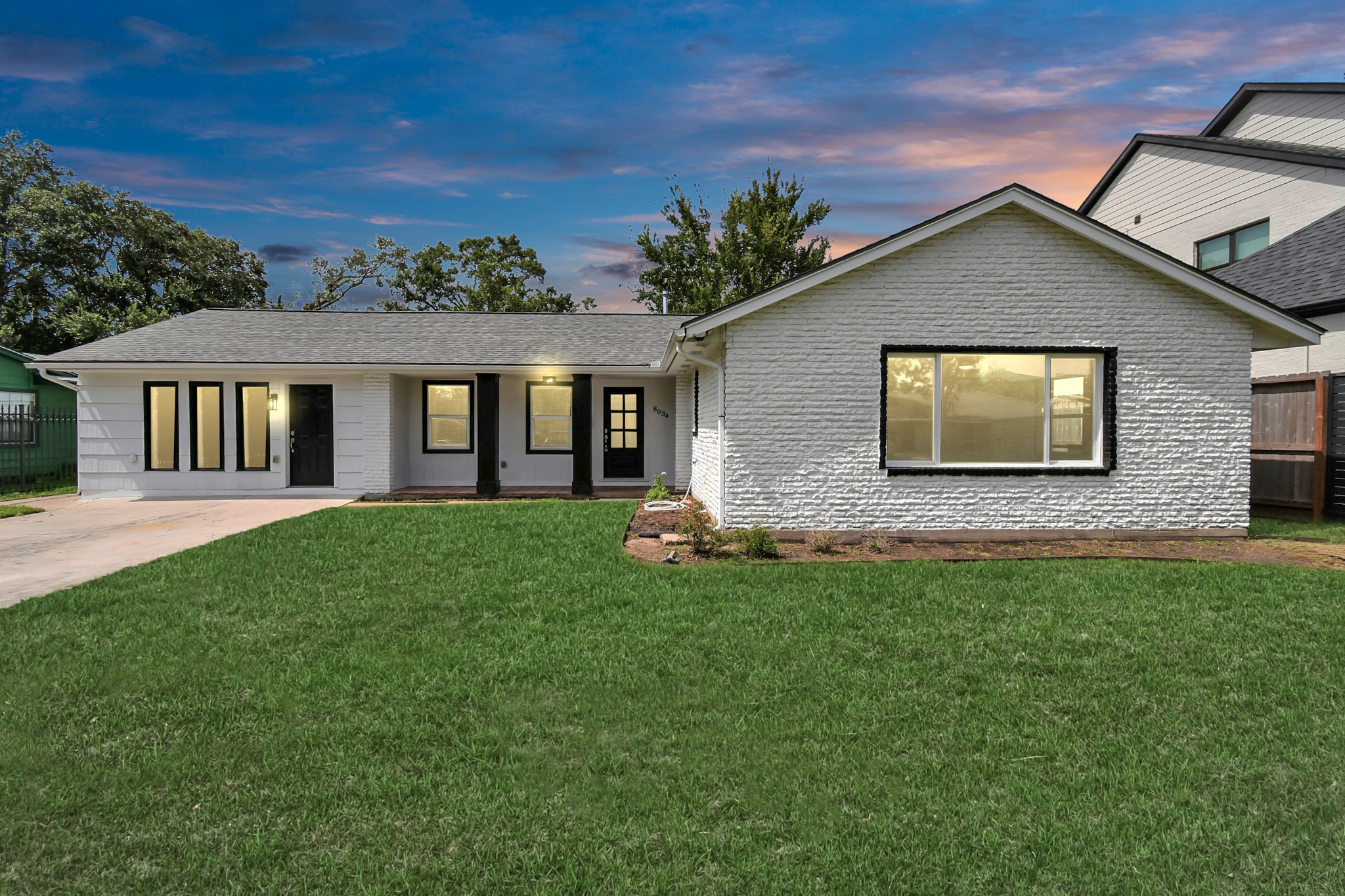 8034 Ridgeview Drive Houston, TX 77055 - Photo 1 of 44 a front view of a house with a garden