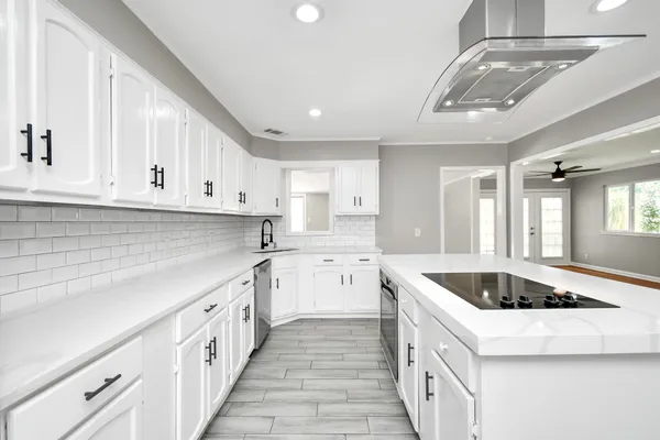 a kitchen that has a sink and a stove top oven