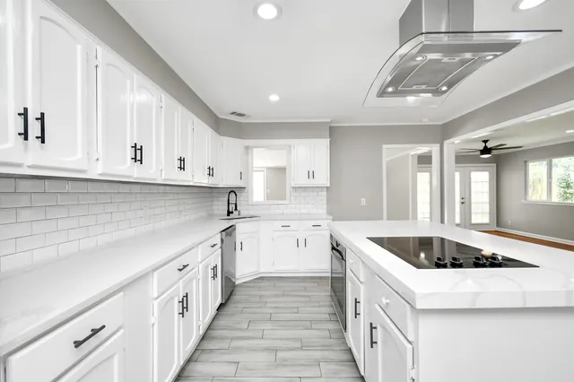 a kitchen that has a sink and a stove top oven