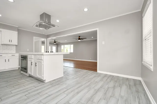 a view of a kitchen with a sink and wooden floor