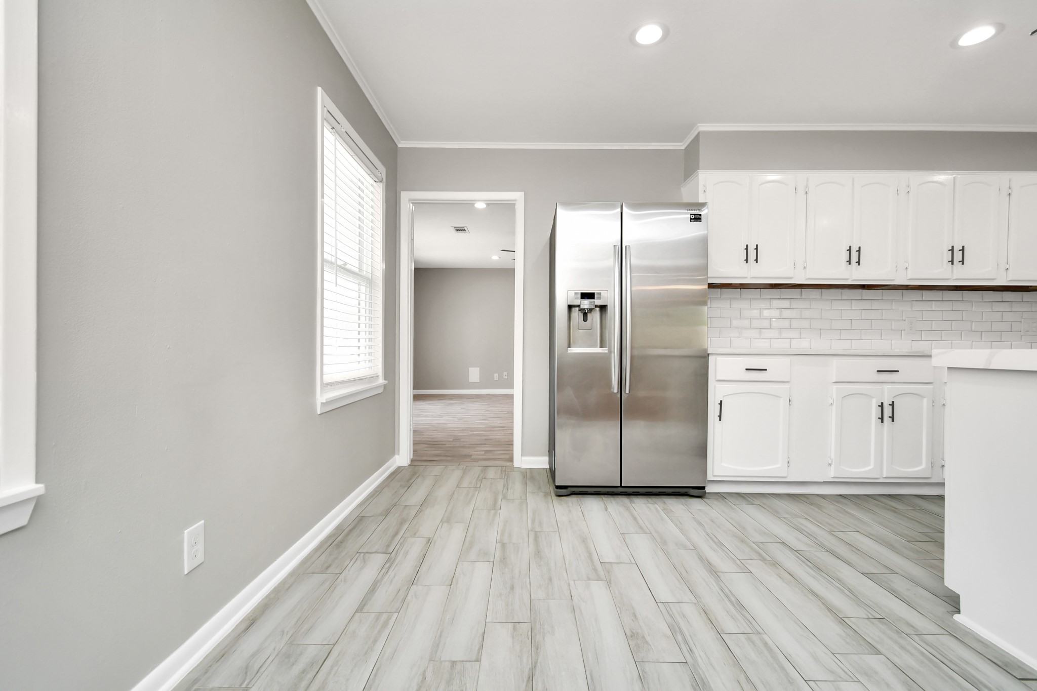 8034 Ridgeview Drive Houston, TX 77055 - Photo 19 of 44 a kitchen with stainless steel appliances a refrigerator and wooden floor