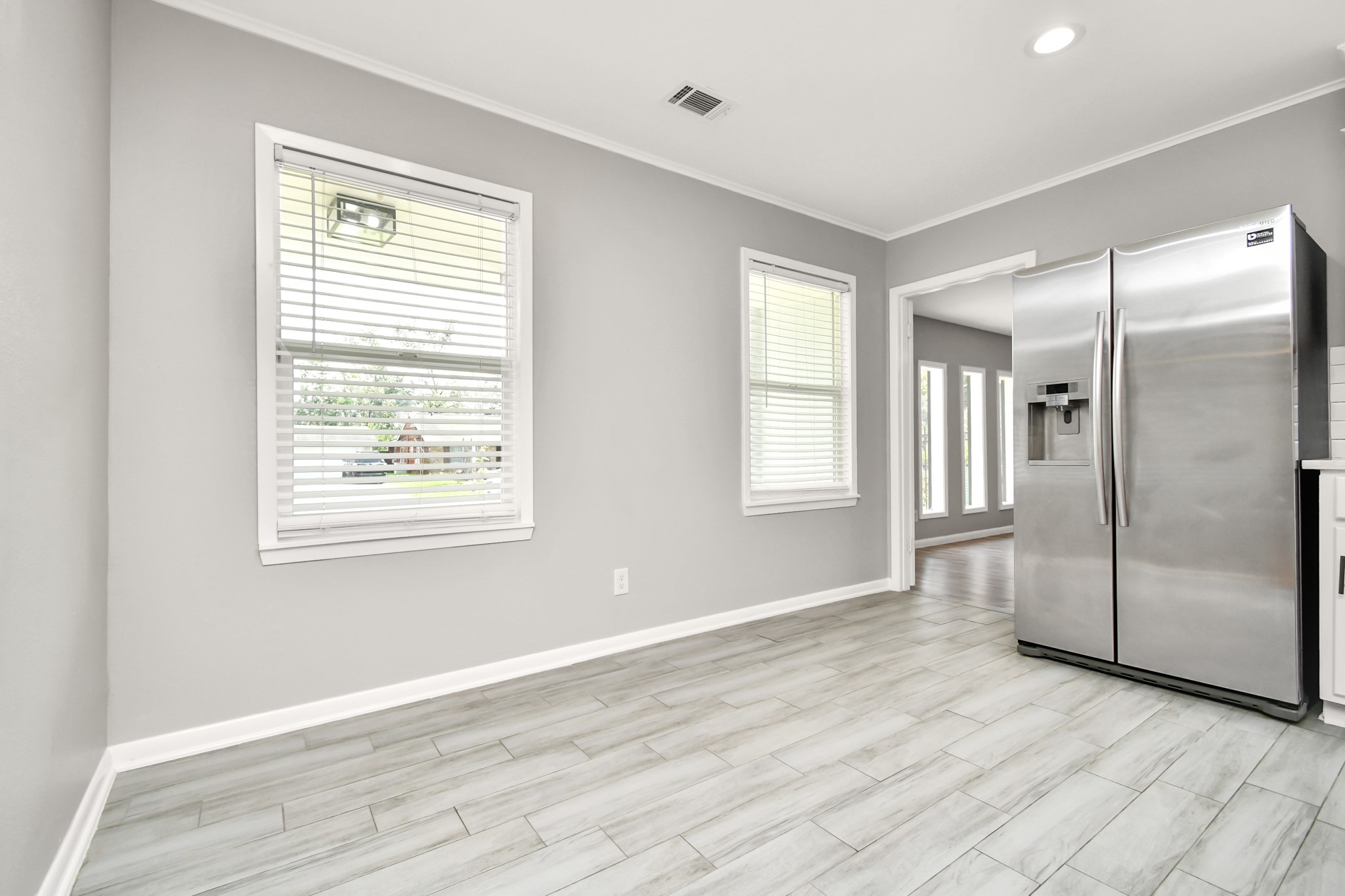 8034 Ridgeview Drive Houston, TX 77055 - Photo 20 of 44 a view of an empty room with wooden floor and a window