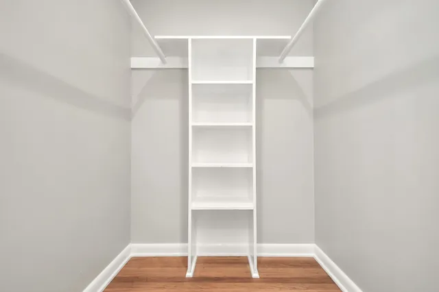 a view of a room with wooden floor