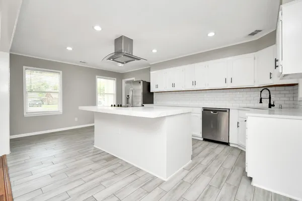 a kitchen with stainless steel appliances a sink stove and cabinets