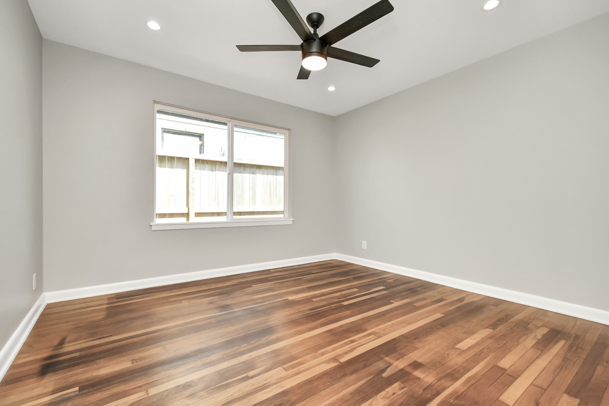 8034 Ridgeview Drive Houston, TX 77055 - Photo 32 of 44 a view of empty room with wooden floor and fan