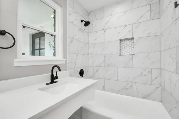 a bathroom with a sink a toilet and mirror