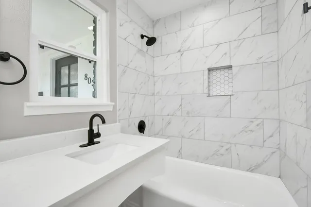 a bathroom with a sink a toilet and mirror