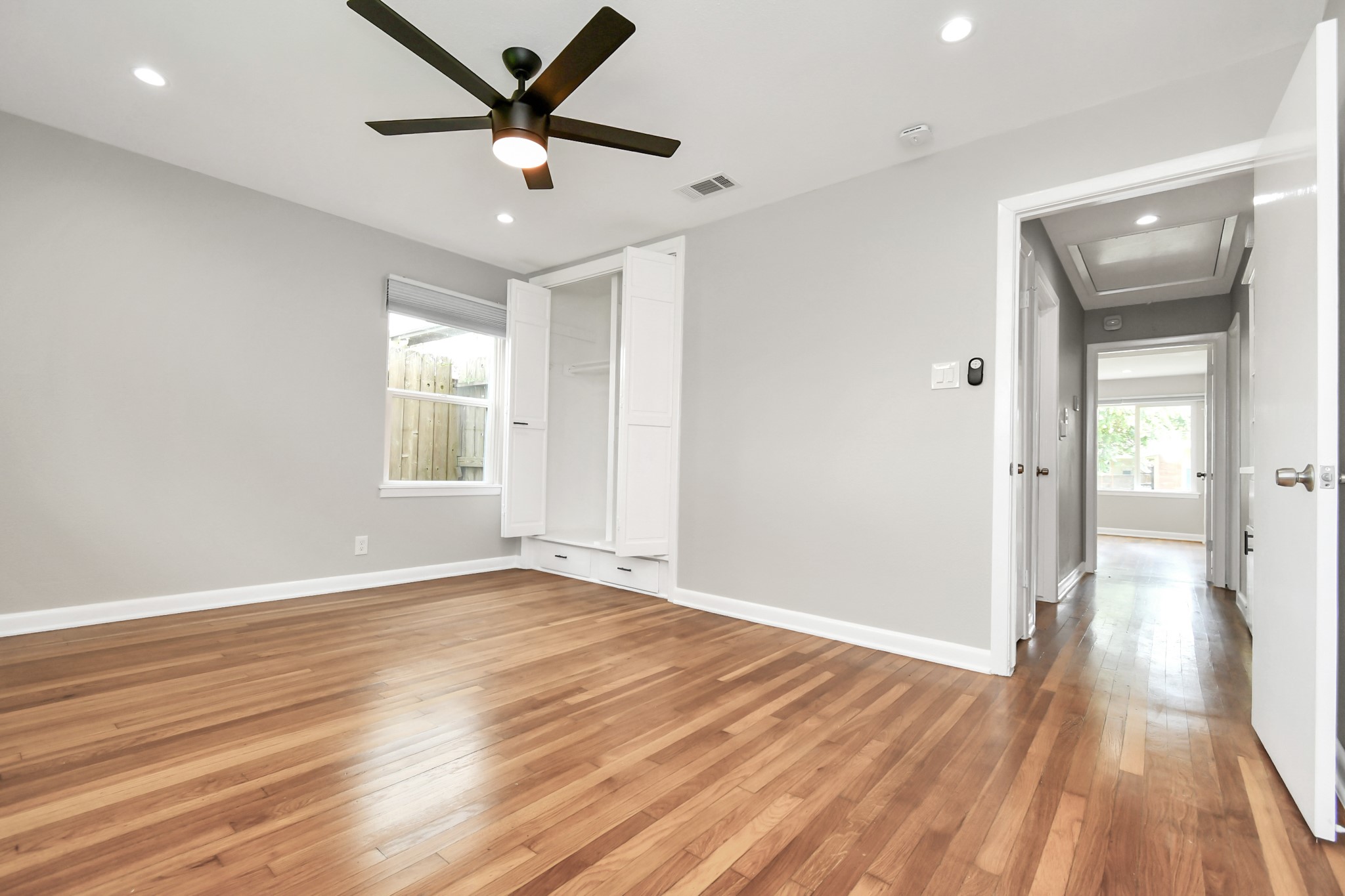 8034 Ridgeview Drive Houston, TX 77055 - Photo 37 of 44 a view of an empty room and window and wooden floor