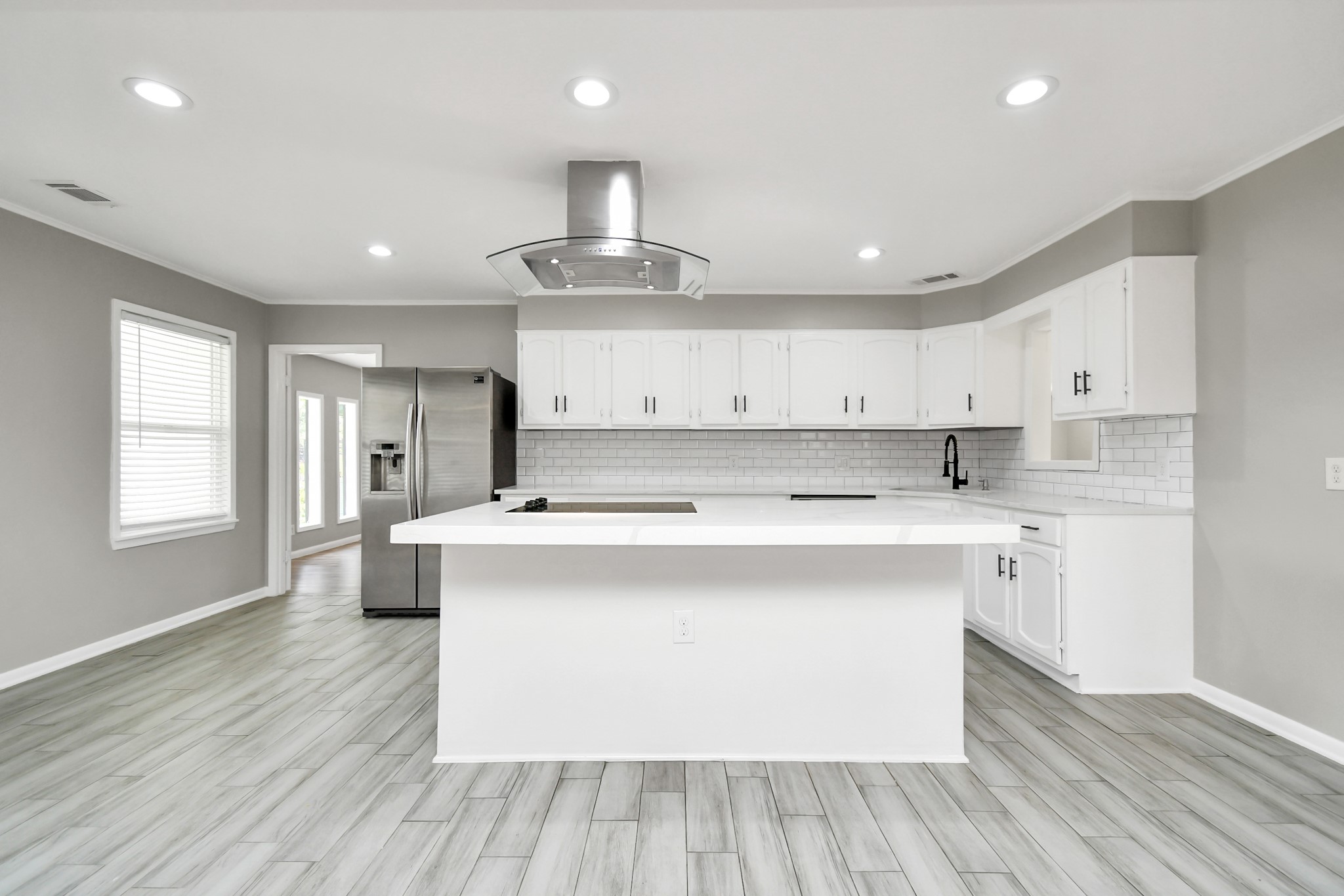8034 Ridgeview Drive Houston, TX 77055 - Photo 4 of 44 a large kitchen with stainless steel appliances granite countertop a lot of counter space and wooden floors
