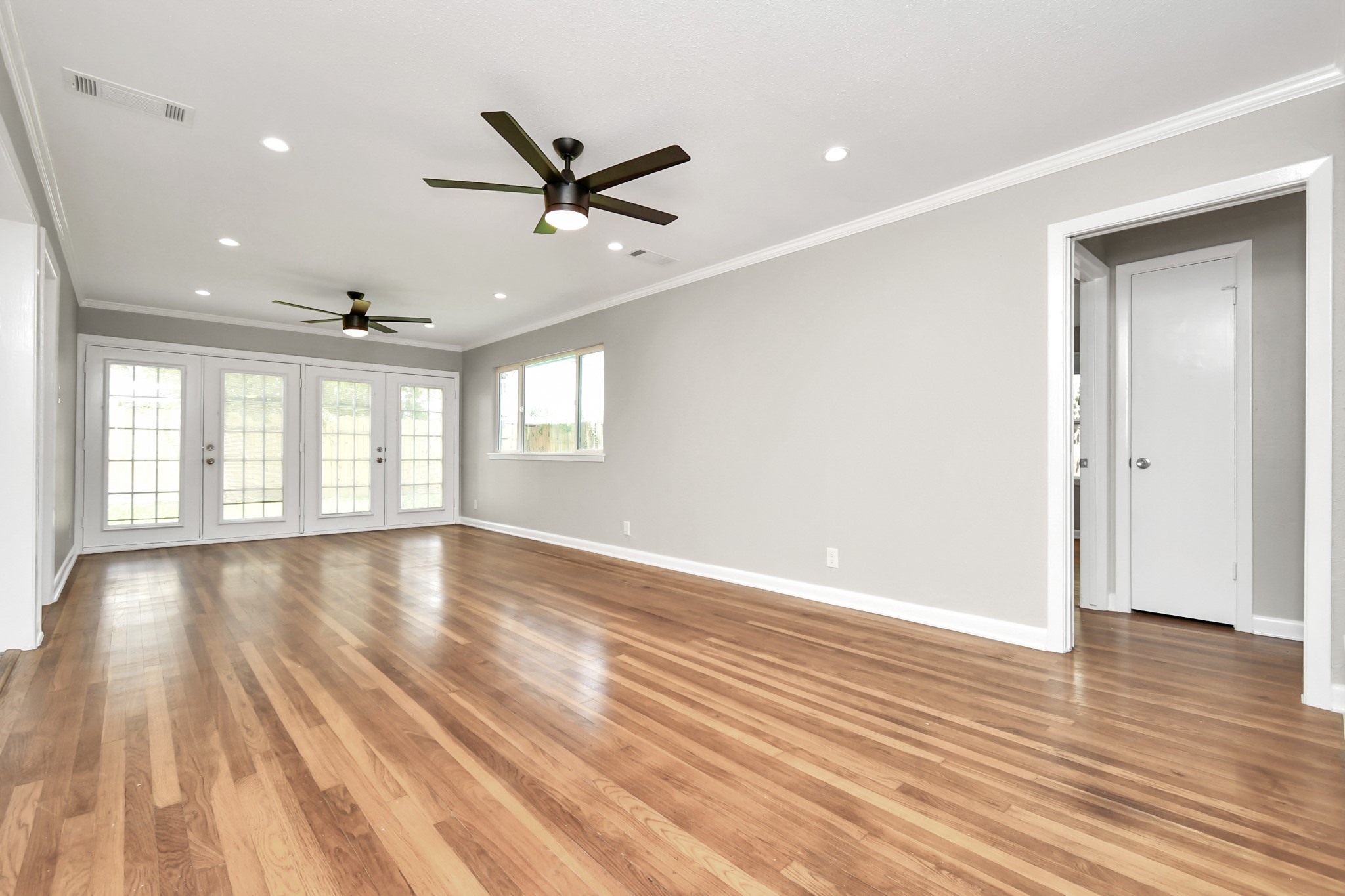 8034 Ridgeview Drive Houston, TX 77055 - Photo 6 of 44 a view of empty room with wooden floor and fan