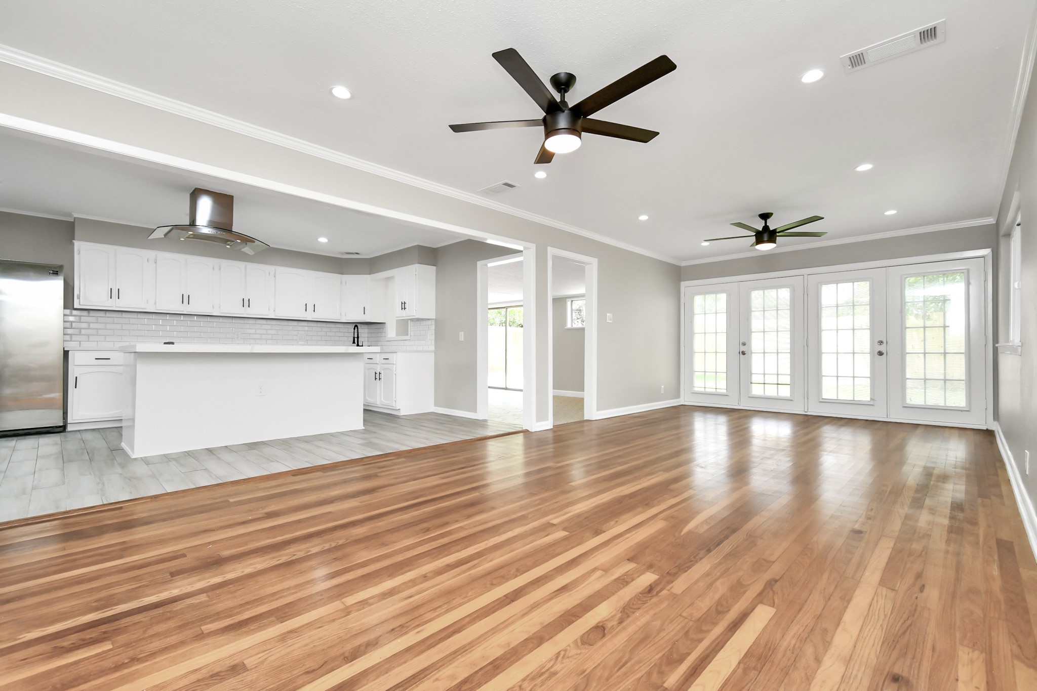 8034 Ridgeview Drive Houston, TX 77055 - Photo 7 of 44 a view of an empty room with wooden floor and a window