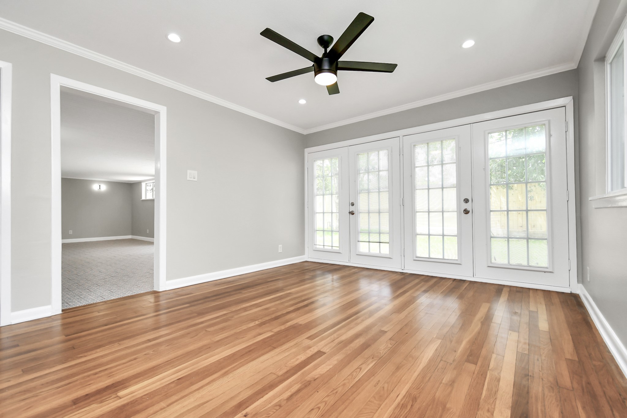 8034 Ridgeview Drive Houston, TX 77055 - Photo 9 of 44 a view of an empty room with a window and wooden floor