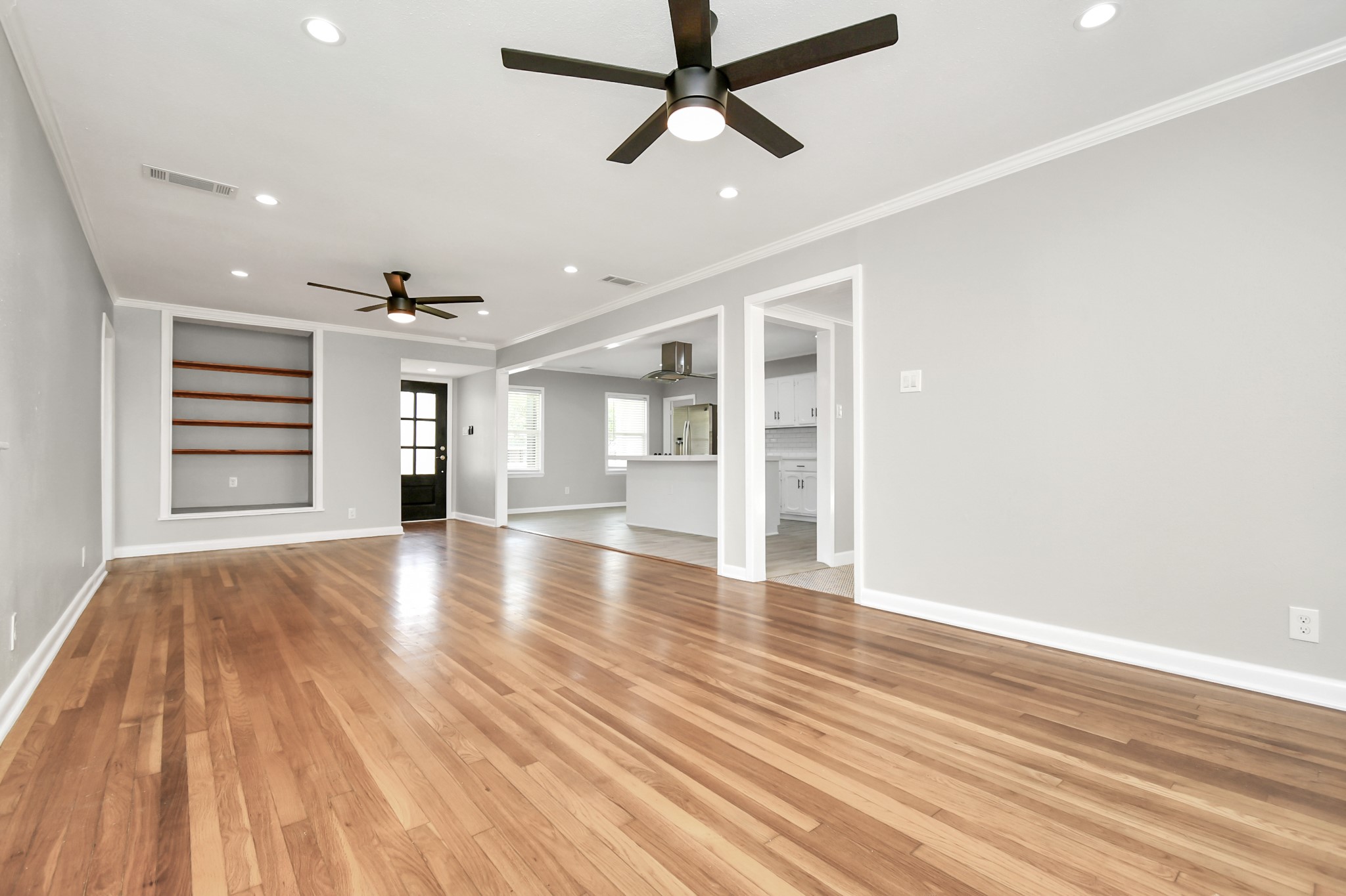 8034 Ridgeview Drive Houston, TX 77055 - Photo 10 of 44 a view of empty room with wooden floor and fan
