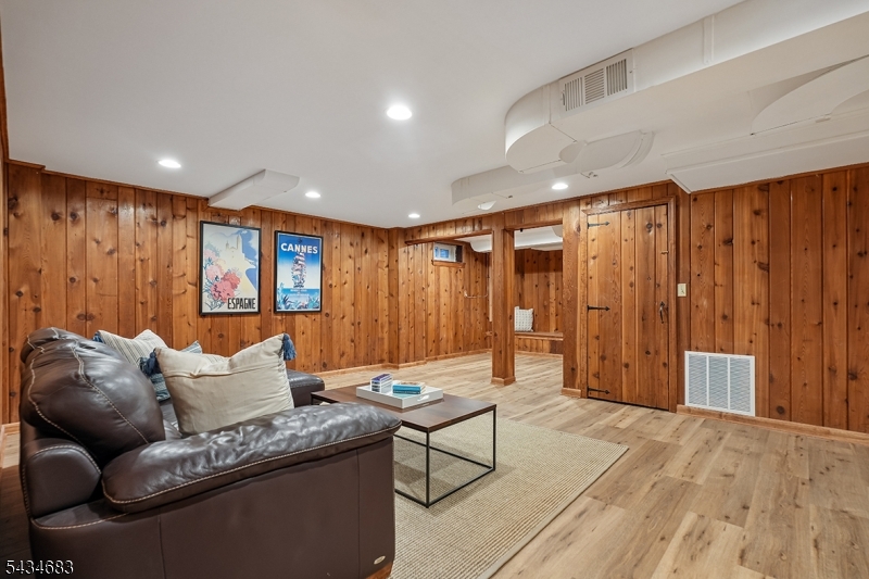 106 Division Avenue Summit, NJ 07901 - Photo 26 of 38 a living room with furniture a ceiling fan and a wooden floor