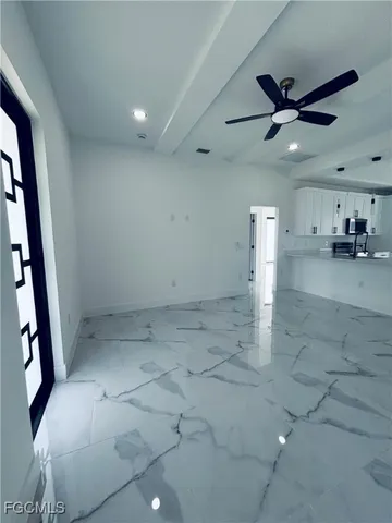 a view of a livingroom with a ceiling fan and window