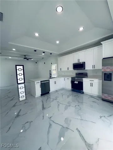 a kitchen with stainless steel appliances a refrigerator sink and cabinets