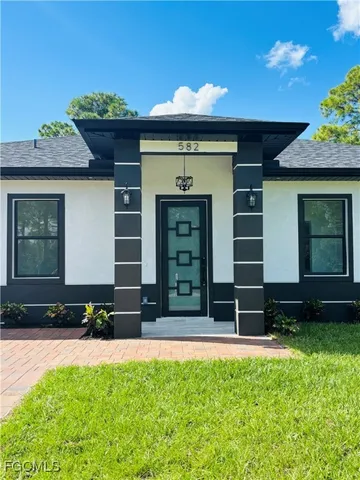 a front view of a house with a garden