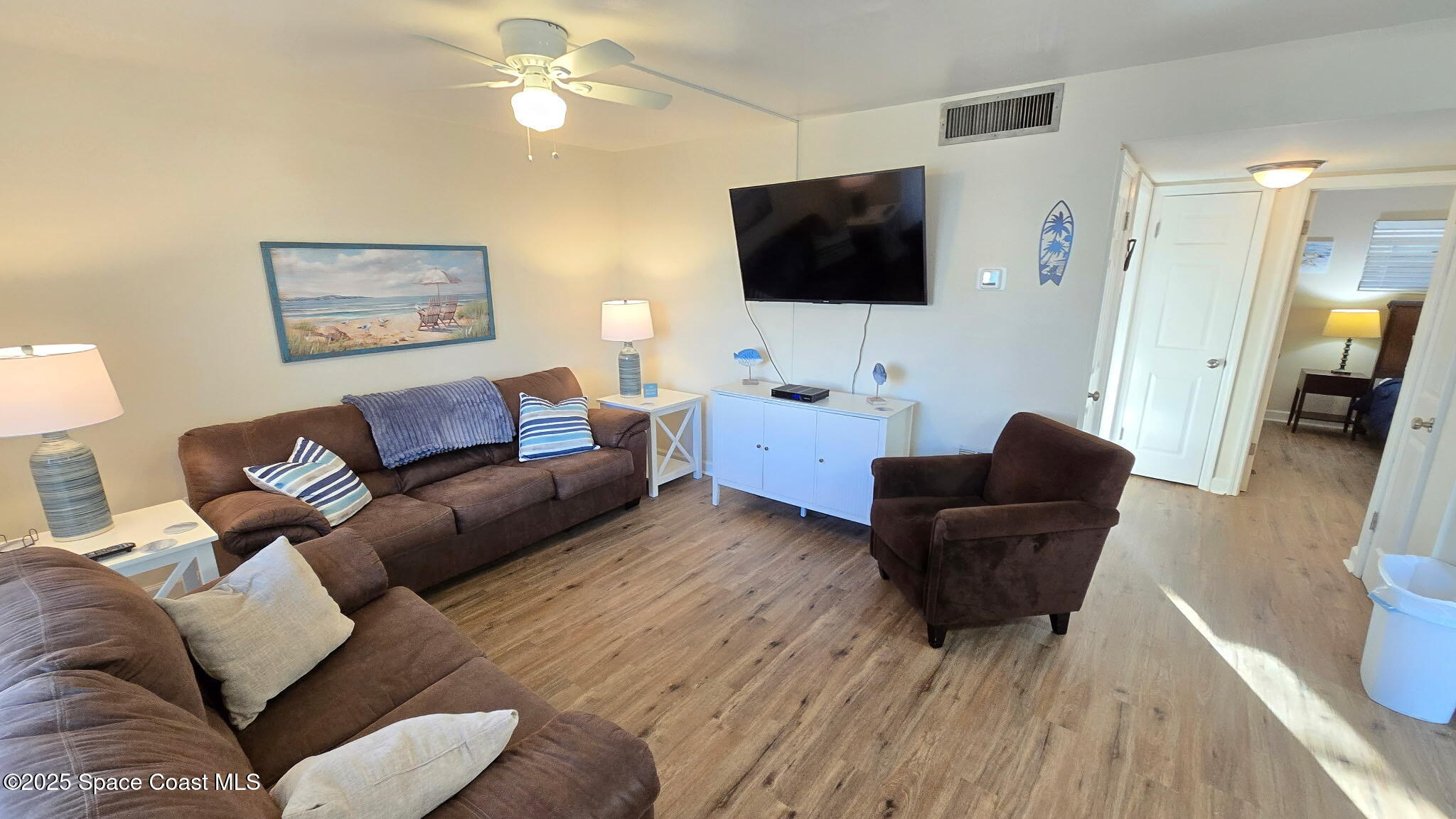 3150 North Atlantic Avenue, Unit 1770 Cocoa Beach, FL 32931 - Photo 13 of 21 a living room with furniture and a flat screen tv