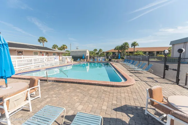 a view of a swimming pool with a patio