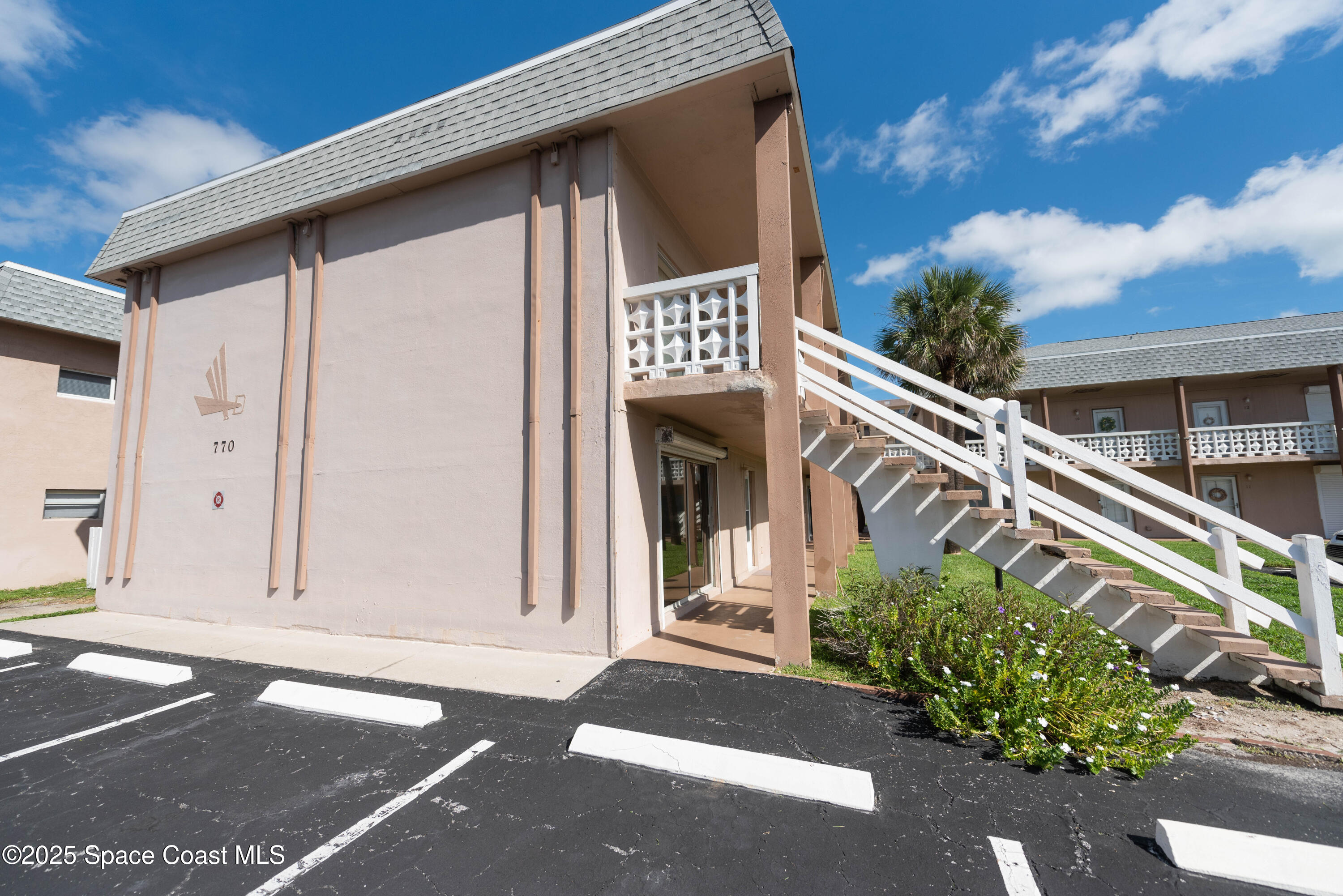 3150 North Atlantic Avenue, Unit 1770 Cocoa Beach, FL 32931 - Photo 17 of 21 a front view of a house with a garage