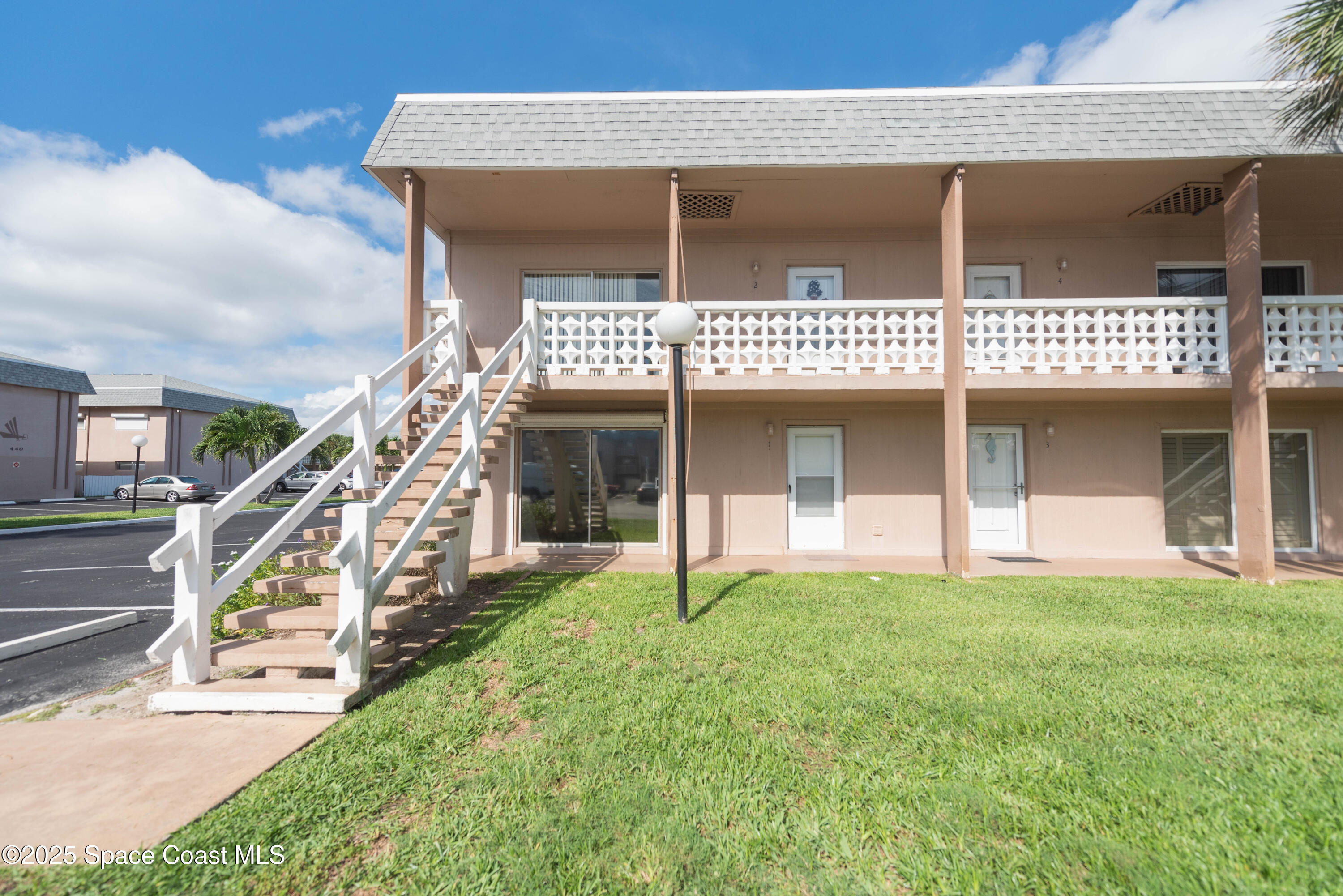 3150 North Atlantic Avenue, Unit 1770 Cocoa Beach, FL 32931 - Photo 19 of 21 a front view of a house with a yard