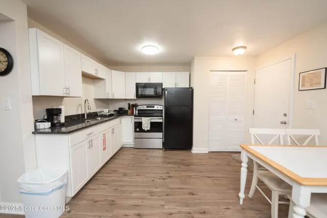 a kitchen with stainless steel appliances a refrigerator stove and sink