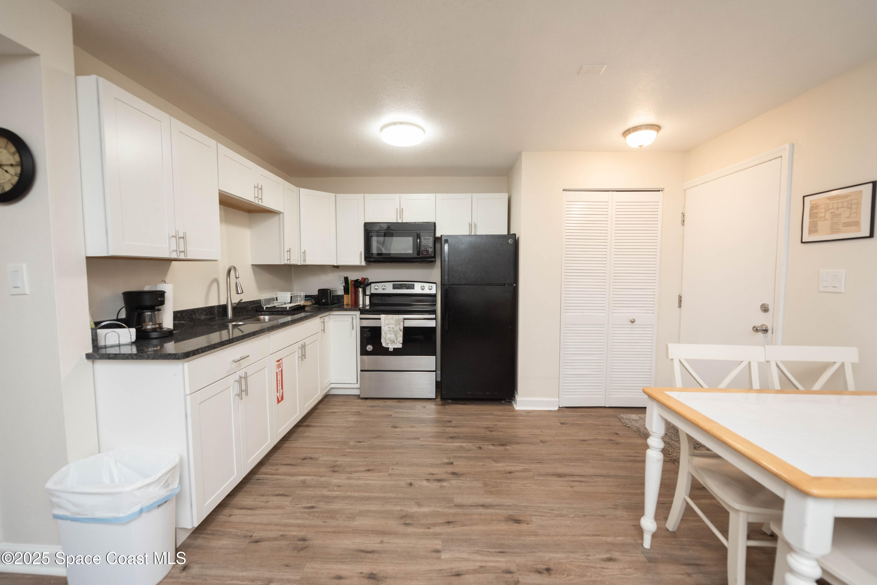 3150 North Atlantic Avenue, Unit 1770 Cocoa Beach, FL 32931 - Photo 5 of 21 a kitchen with stainless steel appliances a refrigerator stove and sink