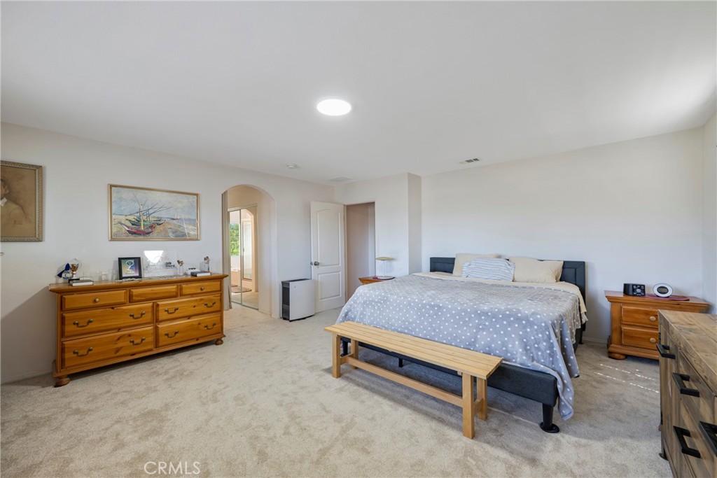3819 St Austell Way Perris, CA 92571 - Photo 41 of 64 a spacious bedroom with a bed and furniture