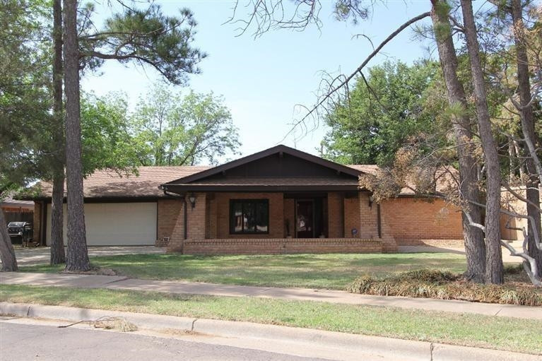 4635 30th Street Lubbock, TX 79410 - Photo 1 of 1 a front view of a house with a garden