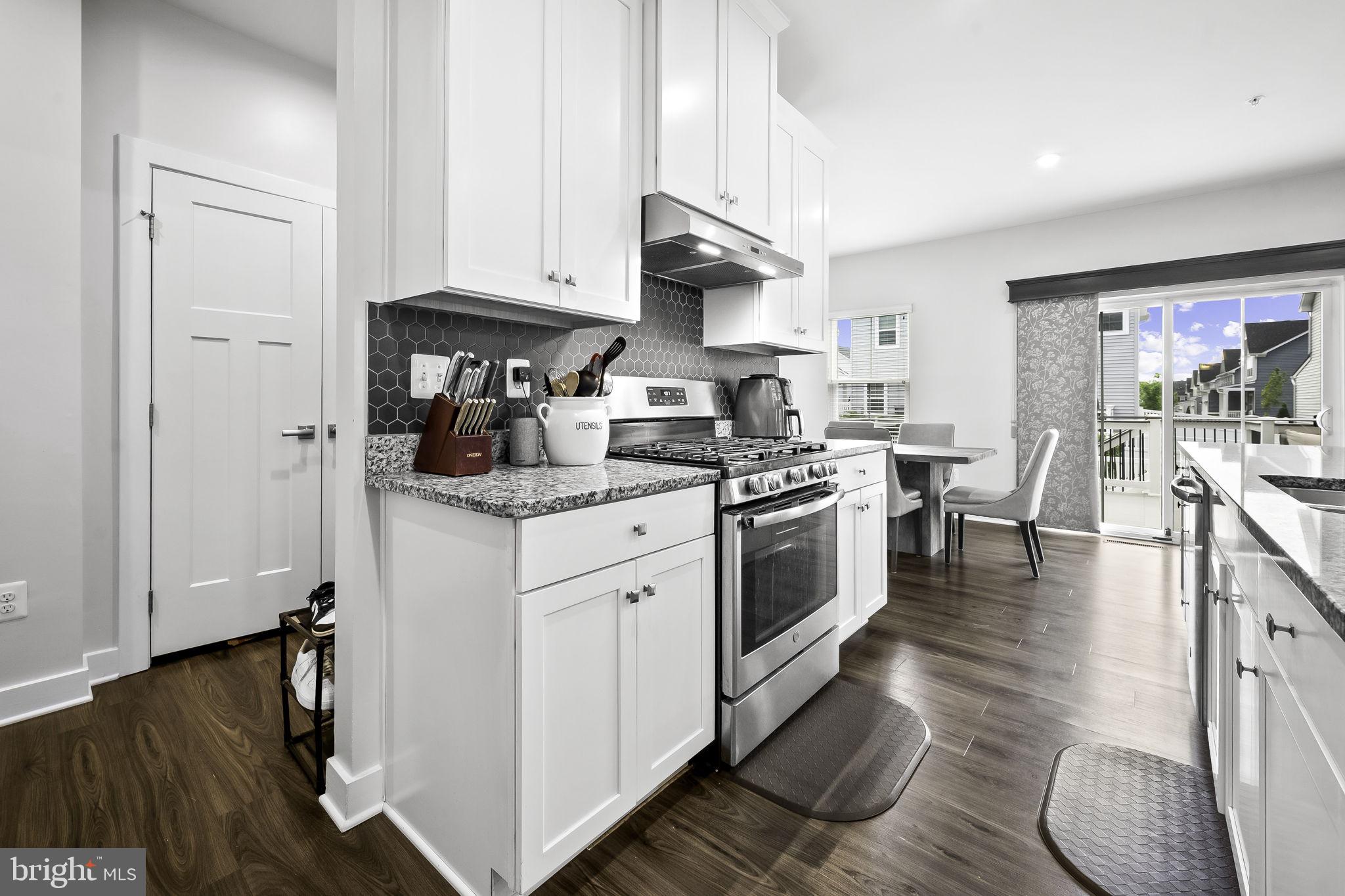 2157 Nottoway Drive Hanover, MD 21076 - Photo 13 of 50 a kitchen with stainless steel appliances granite countertop a stove a sink dishwasher and a refrigerator with wooden floor