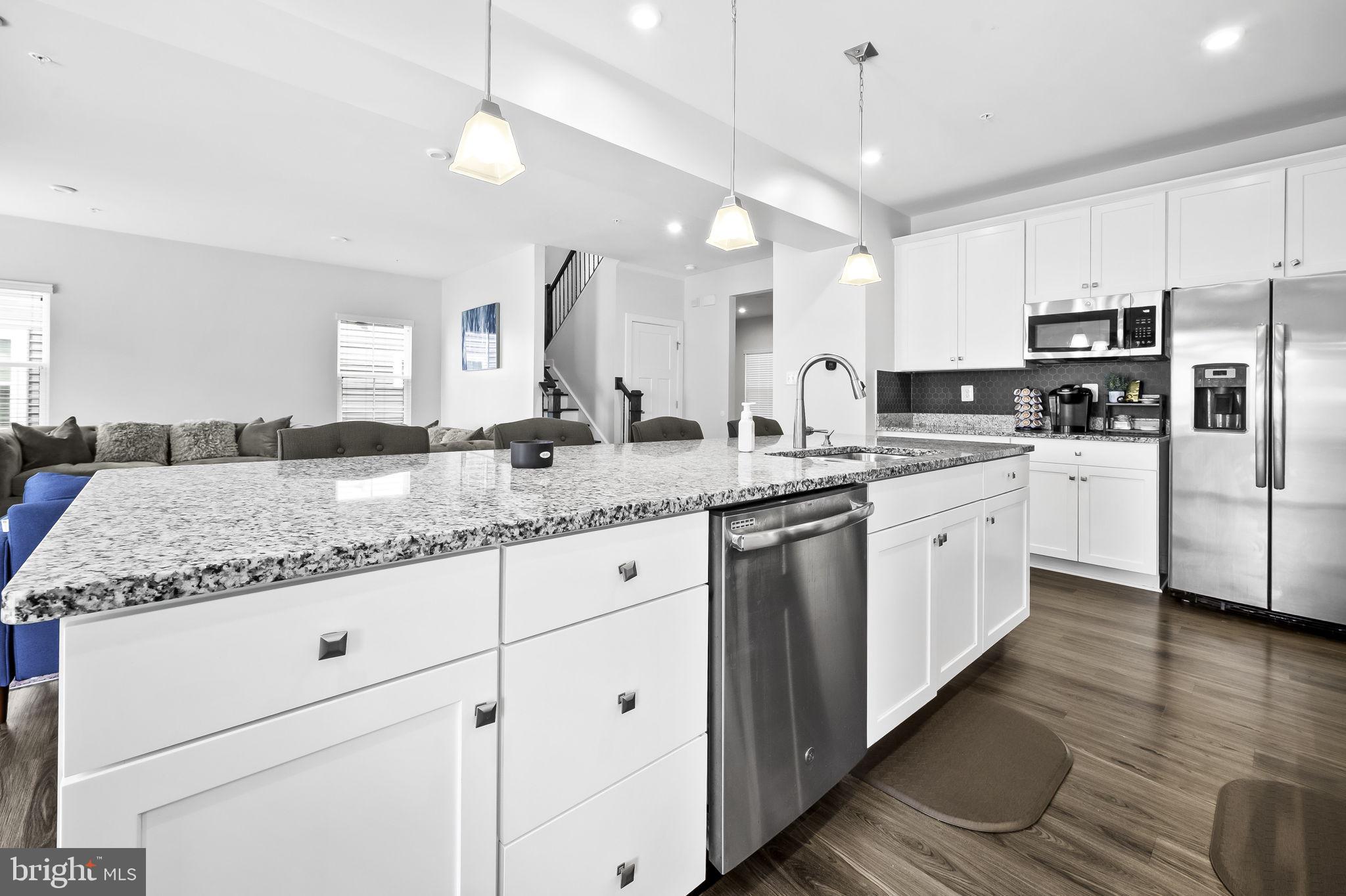 2157 Nottoway Drive Hanover, MD 21076 - Photo 15 of 50 a kitchen with stainless steel appliances granite countertop a sink a stove a refrigerator and island with wooden floor