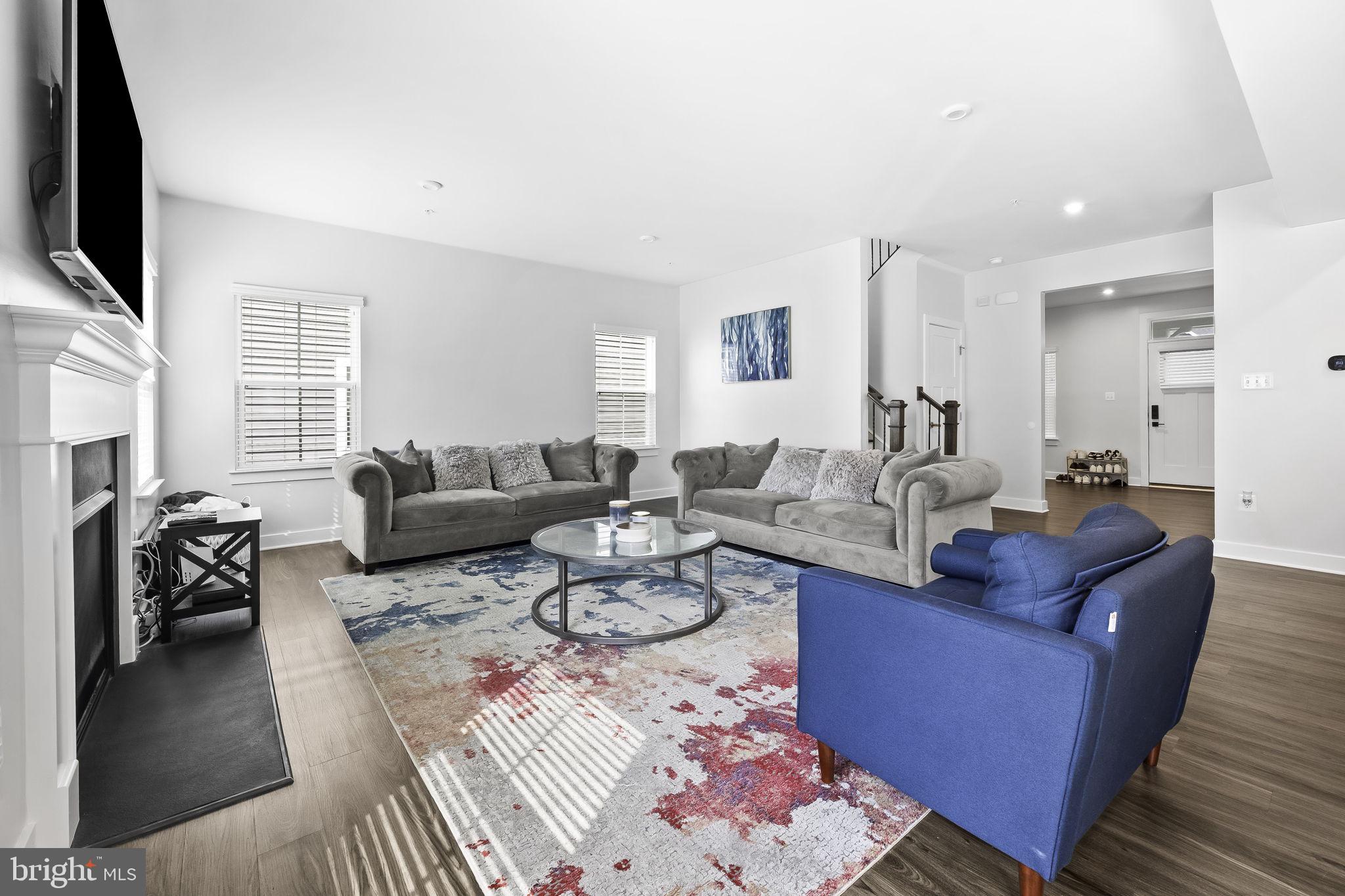 2157 Nottoway Drive Hanover, MD 21076 - Photo 18 of 50 a living room with furniture a flat screen tv and a large window