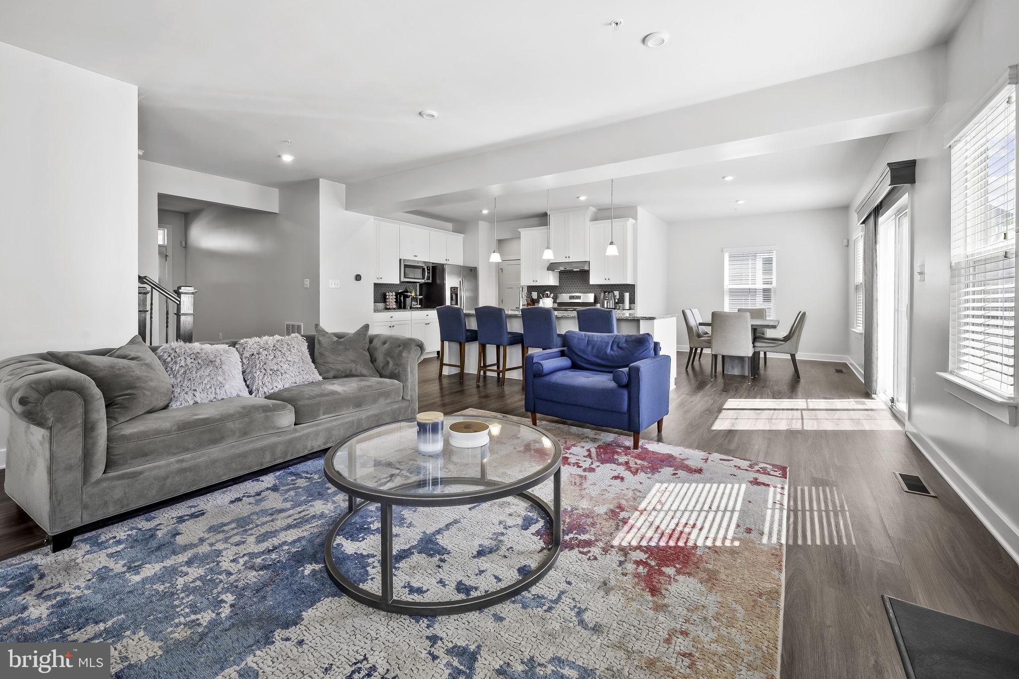 2157 Nottoway Drive Hanover, MD 21076 - Photo 19 of 50 a living room with furniture and a dining table with wooden floor