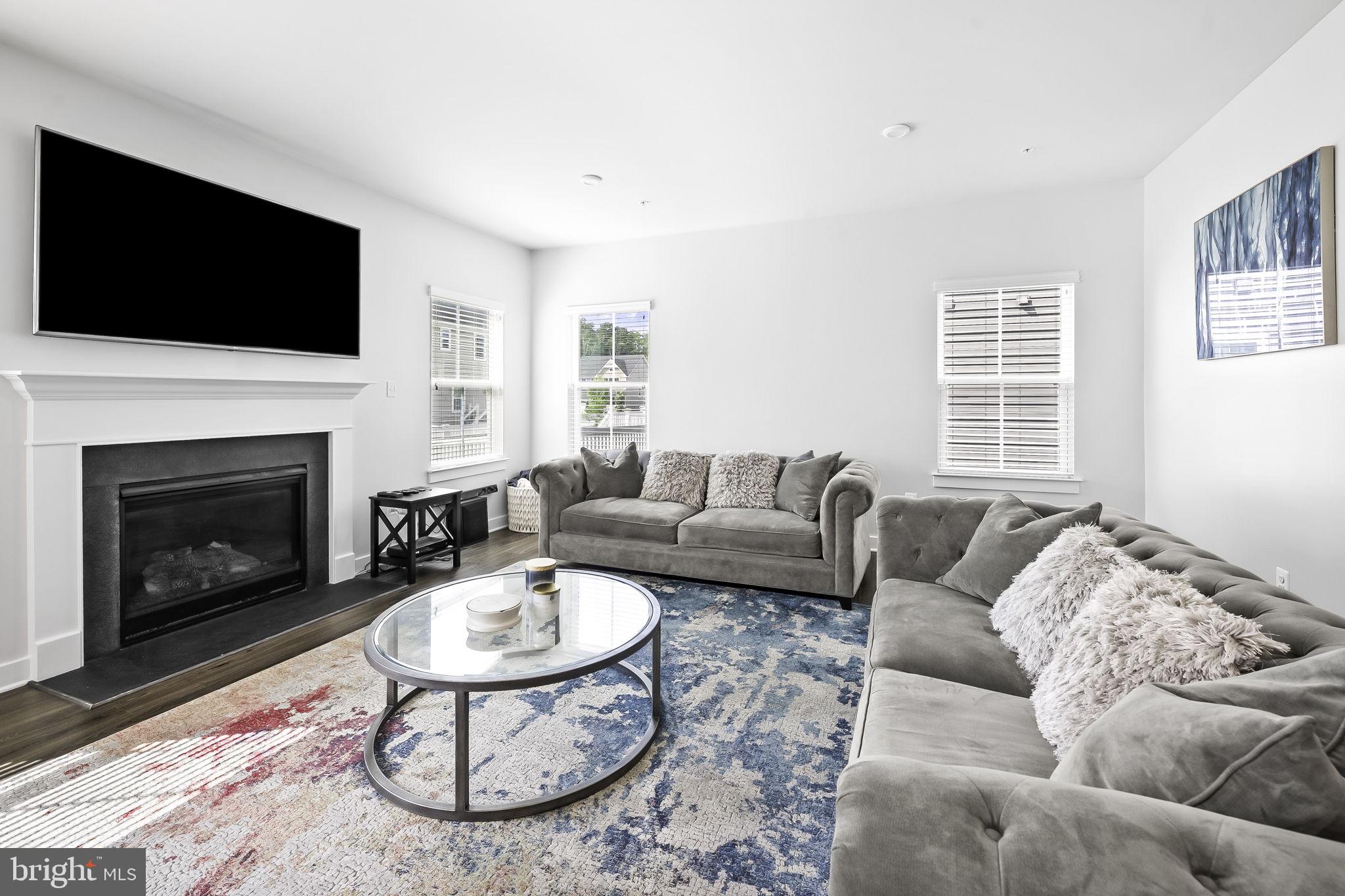 2157 Nottoway Drive Hanover, MD 21076 - Photo 20 of 50 a living room with furniture a flat screen tv and a fireplace