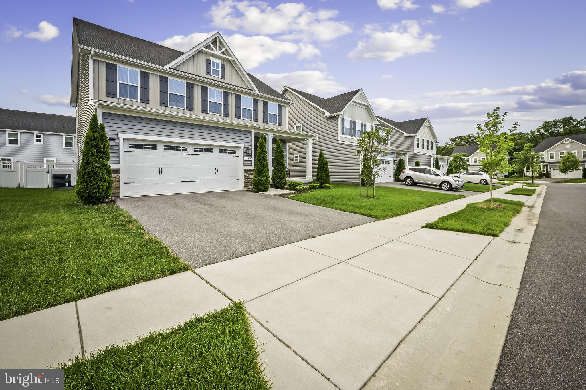 2157 Nottoway Drive Hanover, MD 21076 - Photo 2 of 50 a front view of a house with a yard and garage