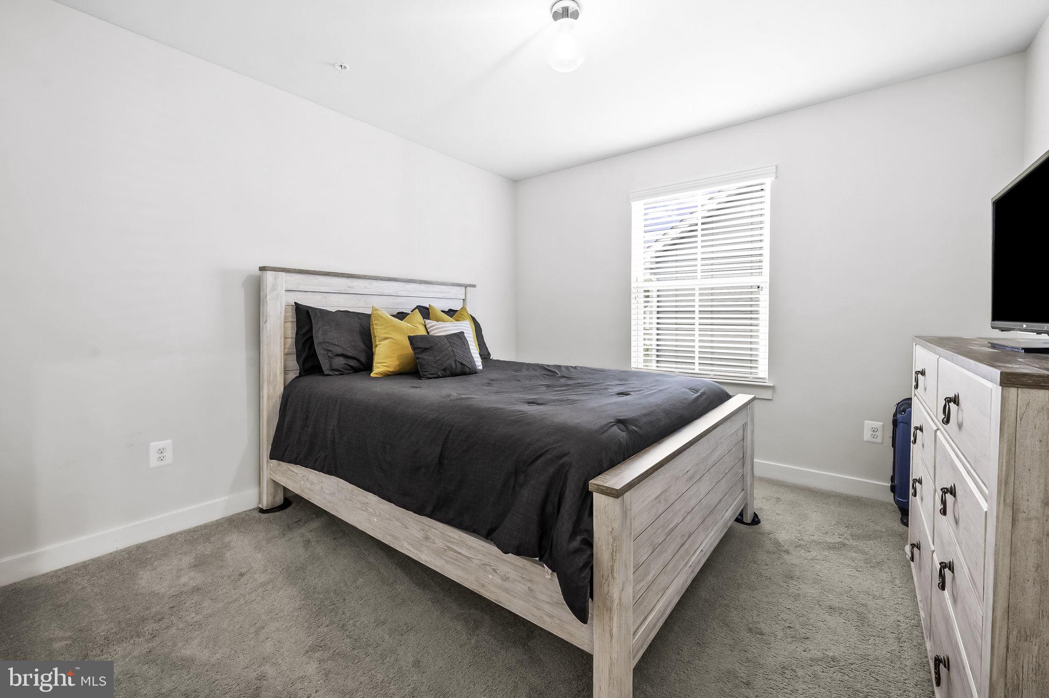 2157 Nottoway Drive Hanover, MD 21076 - Photo 24 of 50 a bedroom with a bed and a flat tv screen on the dresser