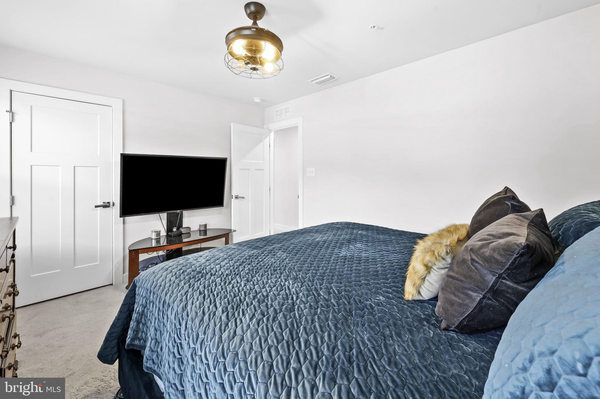 2157 Nottoway Drive Hanover, MD 21076 - Photo 28 of 50 a bedroom with a bed and a flat screen tv