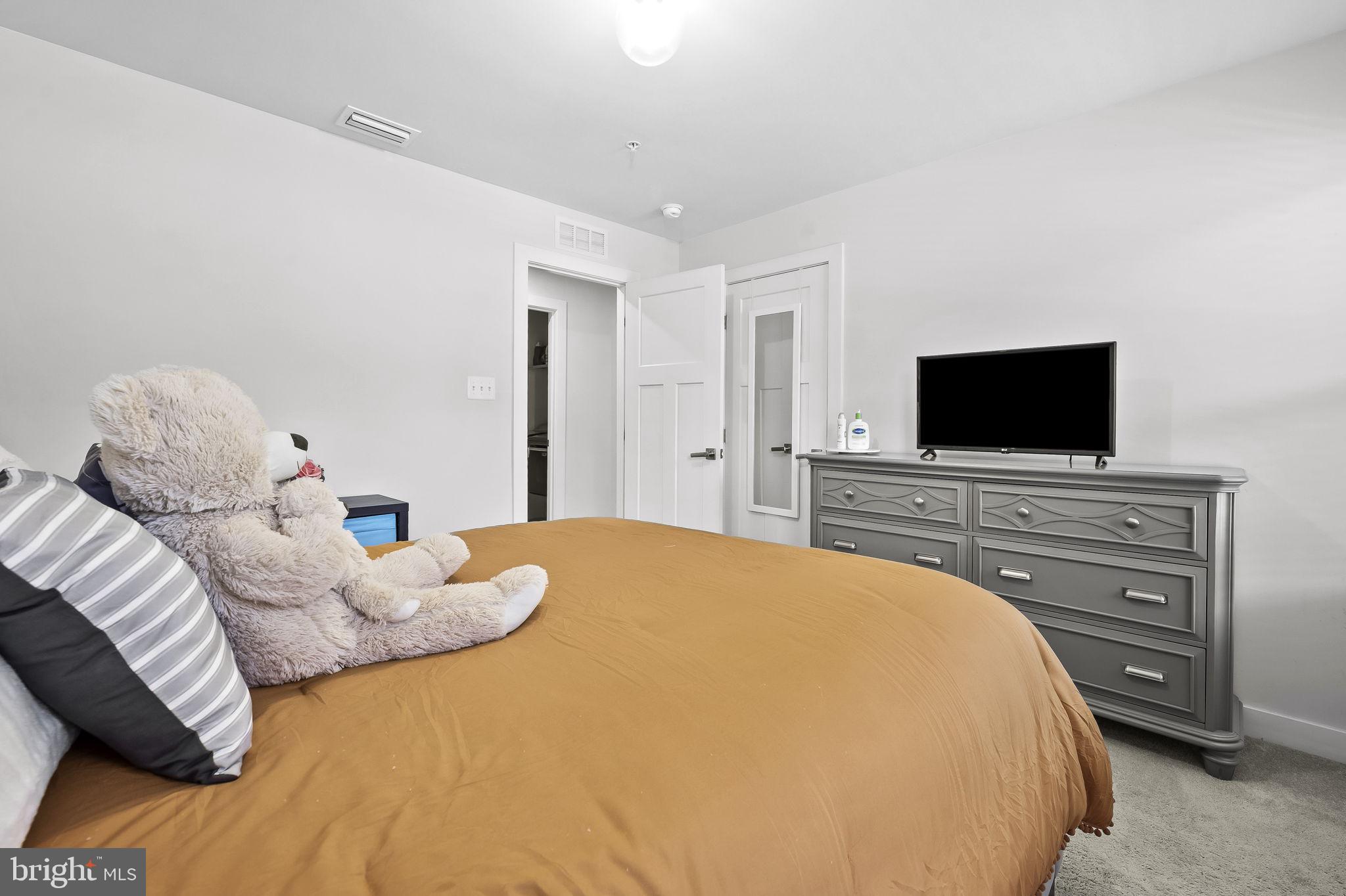 2157 Nottoway Drive Hanover, MD 21076 - Photo 31 of 50 a bedroom with a bed and a flat screen tv